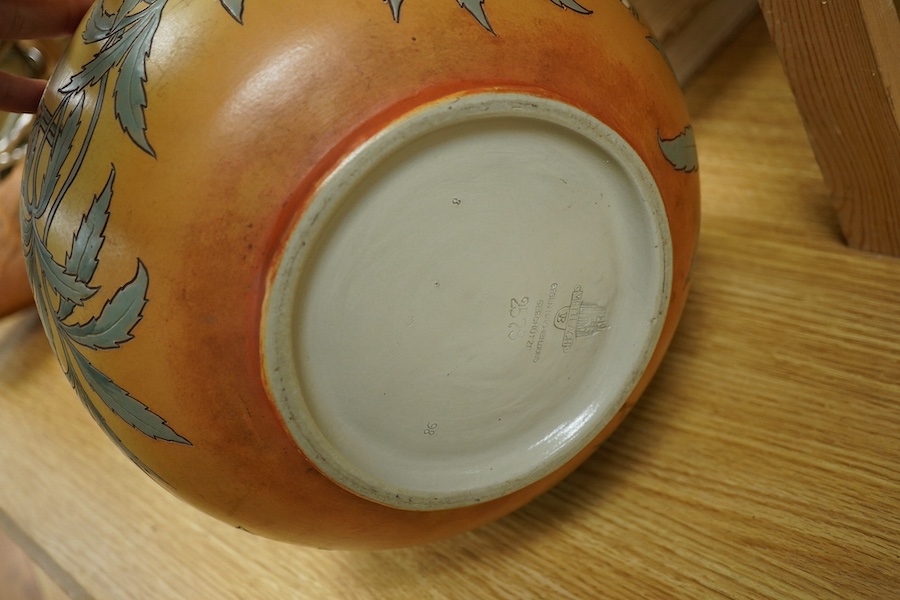 A Mettlach stoneware floral vase, impressed marks, 36cm high. Condition - fair/good